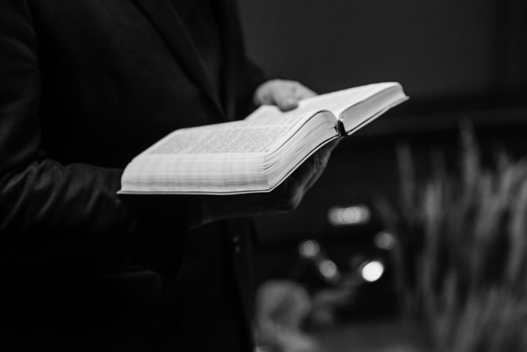 pexels-photo-7317744-7317744 Grayscale close-up of a person holding an open Bible, conveying a sense of faith.